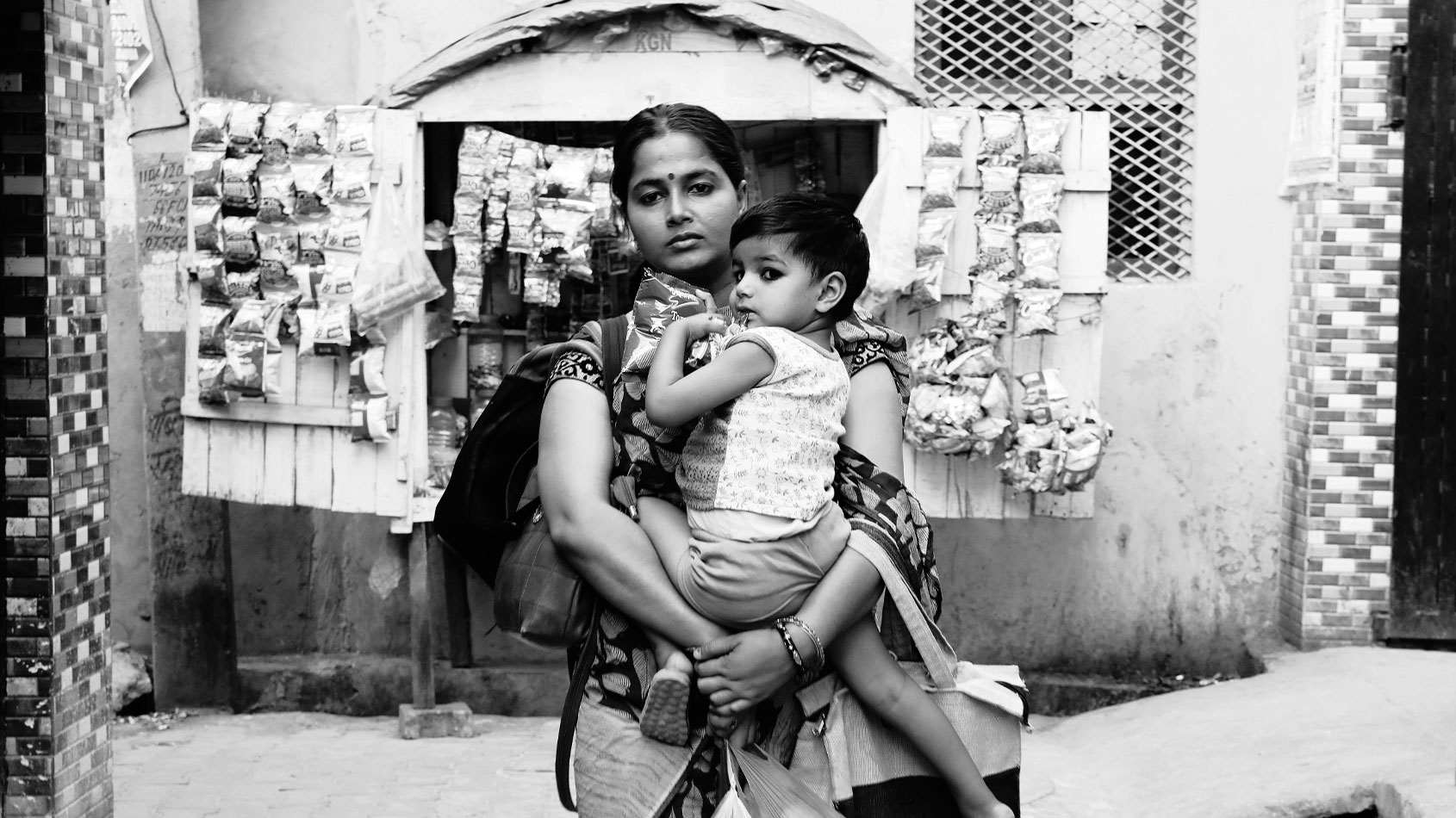 Woman carrying child and shopping bags