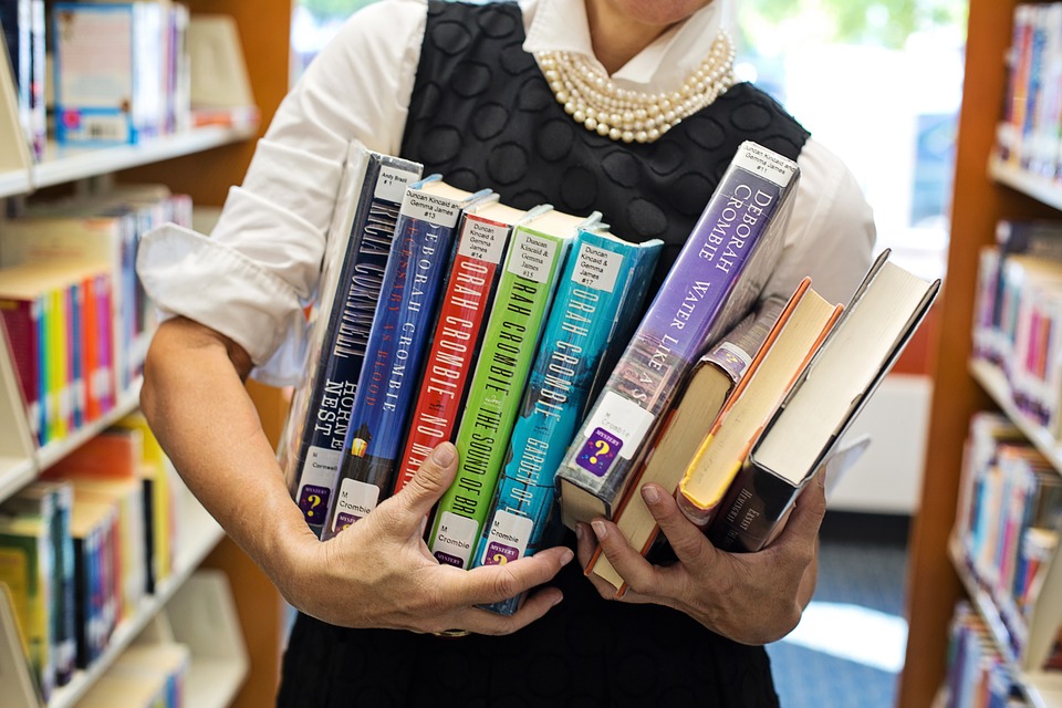 A person holding a set of books
